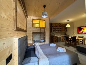 a bedroom with a bed and a dining room at Apartament Rodzinny Deluxe in Poronin
