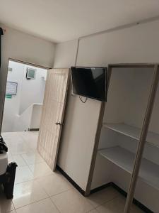 a room with a tv on top of a wall at Hotel Confort Boutique in Rionegro
