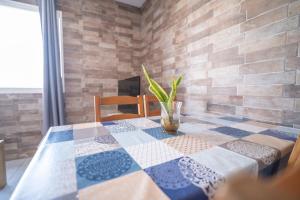 a table with a table cloth on it with a plant on it at Edificio Prieto VIV 5 in Puerto del Rosario