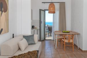 a living room with a couch and a table at Arlen Beach Hotel in Hersonissos