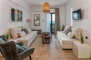 a living room with a couch and a table at Arlen Beach Hotel in Hersonissos