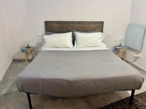 a bedroom with a large bed with two tables at La Scuna Apartments in Corniglia
