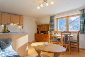 a kitchen and dining room with a table and a kitchen and a dining room at Haus Wörle- Ferienwohnung "Hahle" in Musau