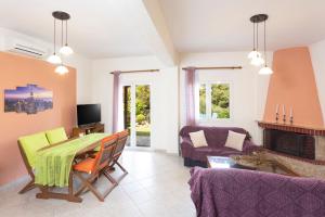 a living room with a table and a couch at Serene Villa in Kriopigi