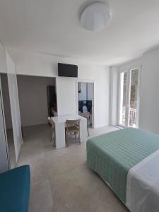 a bedroom with a bed and a table and chairs at Dimore Marche Porto Recanati in Porto Recanati