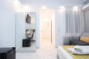 a small bedroom with a bed and a mirror at Syntagma Luxury Apartment in Athens