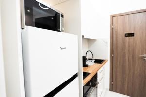 a kitchen with a refrigerator with a microwave on top at Syntagma Luxury Apartment in Athens