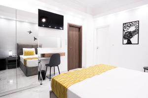 a hotel room with a bed and a desk and a bedroom at Syntagma Luxury Apartment in Athens +34 photos