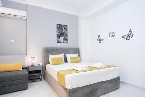 a bedroom with a bed with butterflies on the wall at Syntagma Luxury Apartment in Athens