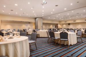 a conference room with tables and chairs and a stage at Pestana Buenos Aires in Buenos Aires +61 photos