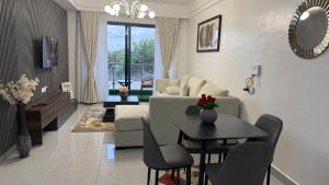 a living room with a couch and a table at Nessie Homes in Nairobi