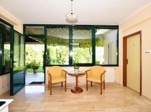 a living room with a table and two chairs at Villa Nature Retreat in Gruda