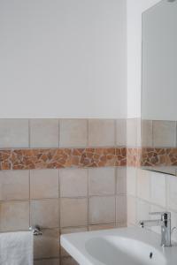 a bathroom with a white sink and a brick wall at Agriturismo La Valle Di Vico in Caprarola +75 photos