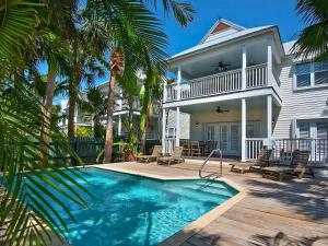 a house with a swimming pool in front of a house at Hawks Cay Resort in Duck Key +234 photos