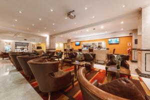 a bar with chairs and tables in a restaurant at Pestana Buenos Aires in Buenos Aires