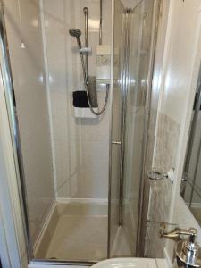a shower with a glass door in a bathroom at Spalite Hotel in Gloucester +39 photos