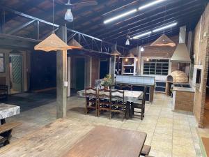 a large kitchen and dining room with a table at Villa Domus in Barretos +18 photos