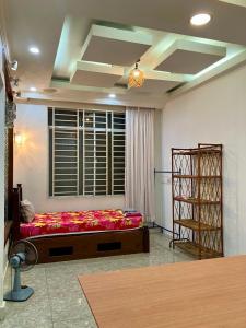 a bedroom with a bed in a room with a window at Combretrata in Phnom Penh