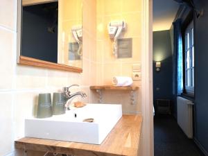 a bathroom with a white sink and a mirror at Hôtel Le Chantilly Deauville in Deauville +97 photos