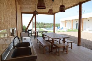 a kitchen with a sink and tables and a patio at Olivale Villas in Campo Maior