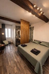 a bedroom with a large bed in a room with a table at Sole Suite & Boutique Rooms in Norma