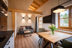 a living room with a table and a couch at Alpenrose in Obermaiselstein