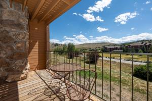 a patio with a table and chairs on a balcony at 564 Silvercreek Inn in Granby