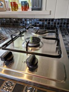 a stove top with two burners on it in a kitchen at Bramblewick House Glamping in Longford +19 photos