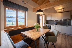 a kitchen and dining room with a wooden table at Alpenrose in Obermaiselstein