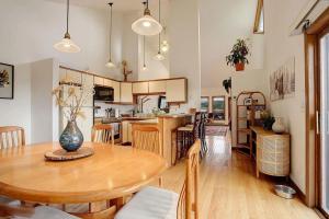 a kitchen and dining room with a wooden table at 534 Sun River #8 in Fraser +21 photos