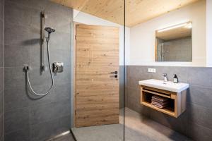 a bathroom with a shower and a sink at Alpenrose in Obermaiselstein +25 photos