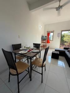 a dining table and chairs in a living room at JG&A Home in Itauguá