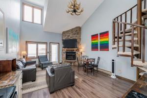 a living room with a couch and a fireplace at 643 Silvercreek Inn Condo in Granby
