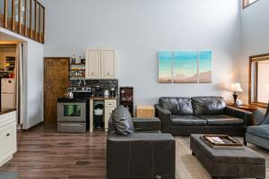 a living room with a couch and a stove at 643 Silvercreek Inn Condo in Granby +26 photos