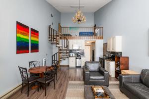 a living room with a spiral staircase and a table at 643 Silvercreek Inn Condo in Granby