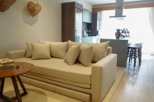 a white couch in a living room with a table at Jungle View Nest Selva Rooftop in Tulum