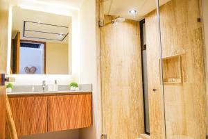 a bathroom with a sink and a mirror at Jungle View Nest Selva Rooftop in Tulum +13 photos