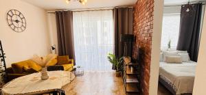 a living room with a couch and a table in a room at Lotus Apartments Natura parking balcony in Ostrołęka