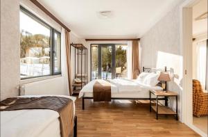 a bedroom with two beds and a window at SetAura Kazbegi in Kazbegi