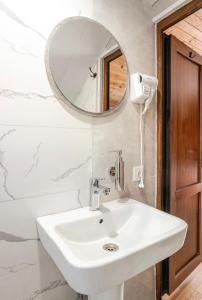 a bathroom with a white sink and a mirror at SetAura Kazbegi in Kazbegi +31 photos