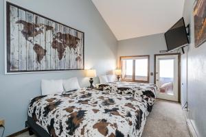 a bedroom with a bed and a map on the wall at 645 Silvercreek Inn Room in Granby