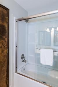 a bathroom with a shower with a glass door at 645 Silvercreek Inn Room in Granby +18 photos
