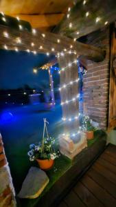 a gazebo with lights and plants on a ledge at Casa il Grappolo in Momo