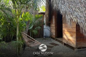 a patio with a chair and a building at Casa Nudista - LGBT Hotel in Zipolite