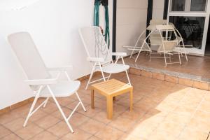 a group of chairs and a table on a porch at Yesenia Vv Airport in El Matorral