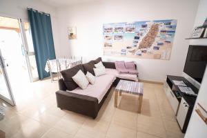 a living room with a couch and a coffee table at Yesenia Vv Airport in El Matorral +15 photos