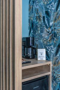 a coffee maker on top of a wooden shelf at Ernest Suites Psiri in Athens