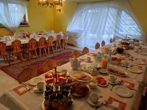 a long table with plates of food on it at Willa Ewa in Poronin
