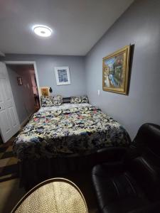 a bedroom with a bed and a chair in it at Queen Private room with private bathroom in Irvington +7 photos