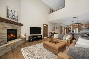 a living room with a couch and a fireplace at 74 Alder Brook in Fraser